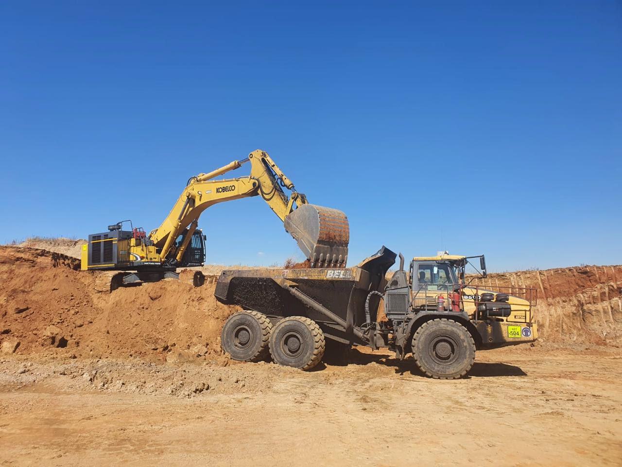 Excavator loading an ADT
